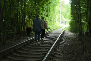 Fototapeta na wymiar people walk on the railway track 