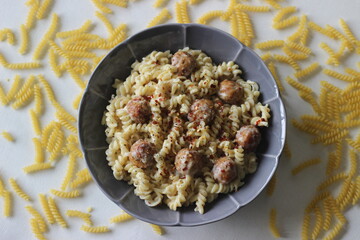 Air fried meat balls in white sauce pasta. Home made.