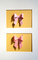 colored paper bow framed with passepartout