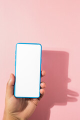 smartphone with white screen on pink background
