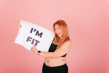Cheerful smiling woman with plus size body pointing on placard