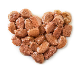 Cat food in the shape of heart close-up on a white background. Top view.