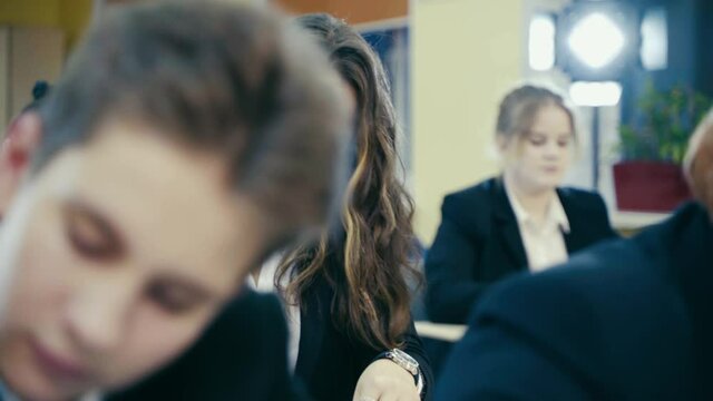 Young students sit at their desks.