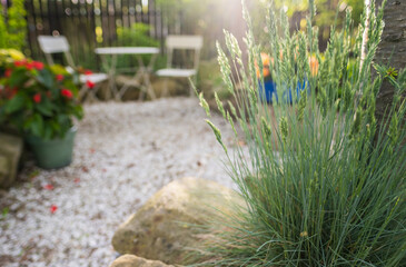 Nature sunset garden with empty bistro coffee table in blurred background