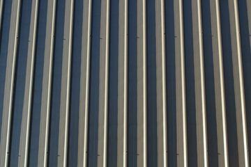 Fence texture. Close-up shot of a ribbed metal structure. Metal fence.
