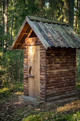 small wooden toilet house in the forest woods