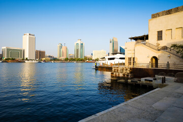 Obraz premium Dubai, UAE, 26 May 2021: Al Seef district in Dubai in the evening. Creek Bur Dubai is a place of Old Traditional Emirati Architectural Building Houses Shops or Souq 