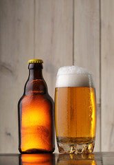 beer bottle with a full glass of alcohol