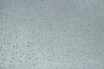 Raindrops on glass. Wet weather outside the window.