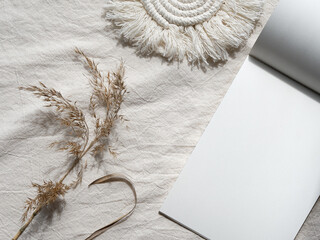 Copy space n block note. Envelope, macrame, pampas grass.. Simple minimal flat lay on ivory textile...