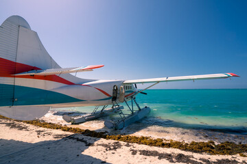 Cool old hydroplane with open door sitting on a sandy beach. Beautiful summer day in Dry Tortugas, Florida. Luxury holiday in tropical paradise. Mexical gulf holiday.