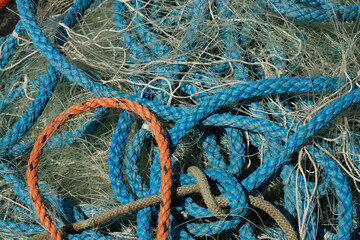 A pile of fishing rope and nylon netting. Close up view filling the frame.