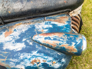 A rusty blue vintage car hood.