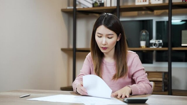 Slow motion frustrated Asian woman looking at the paper bills upset throwing crumpled paper away. mental problems, failure reaction