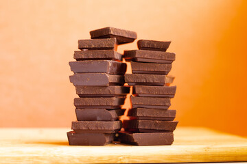 World Chocolate Day pieces of chocolate on an orange background
