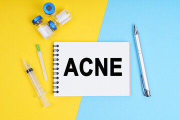 A syringe, ampoules and a notebook with the inscription - ACNE