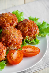 Homemade protein meat balls with vegetables in tomato sauce. Appetizing hot dish on a plate.