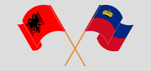 Crossed and waving flags of Albania and Liechtenstein