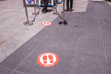 Foot point print sign near entrance to mall to maintain distance during the Covid-19 pandemic, health care