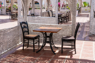 Wooden table and chairs in beach cafe next to the red sea in Sharm el Sheikh, Egypt