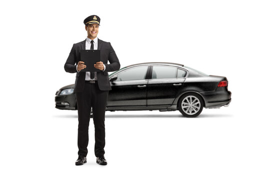 Full Length Portrait Of A Chauffeur Man Holding A Clipboard In Front Of A Black Car