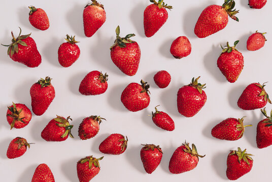 Ripe red strawberries lay down on white background. Flat lay pattern, summer refreshing concept