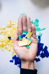 Hand holding hdpe plastic shreded for recycling