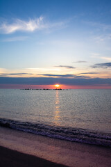 Obraz premium Sunrise on Black sea beach (vertical)