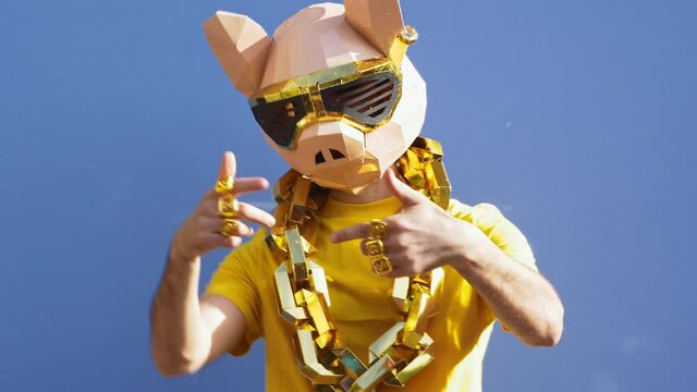 Cool man wearing 3d origami mask with stylish colored clothes 