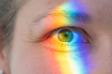 Rainbow color spectrum light on the face. Heart rainbow