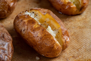 Hot buttered jacket baked potatoes close up