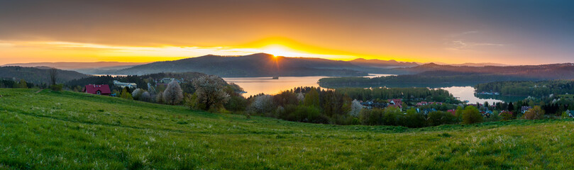Fototapeta na wymiar The April sunrise over Lake Solina seen from the viewpoint in Polańczyk. Polańczyk, Bieszczady