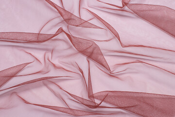 background from a crumpled, compressed red cloth tulle mesh. place for your design