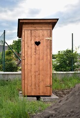 dry toilet in a traditional wooden design, which stands in the garden