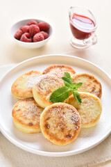 Obraz na płótnie Canvas Cottage cheese pancakes with fresh raspberries