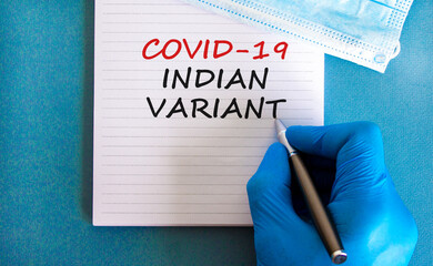 New covid-19 indian variant strain symbol. Hand in blue glove with white card. Concept words...