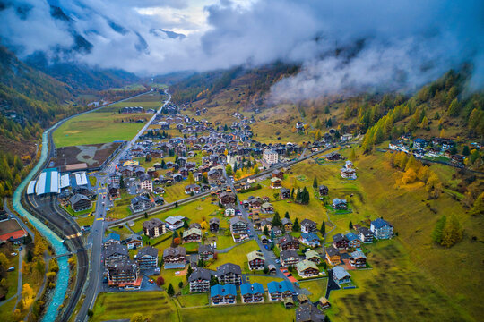 Aerial view of a waving road in countryside going to Ardon township with mountain range in background, Ardon, Switzerland.