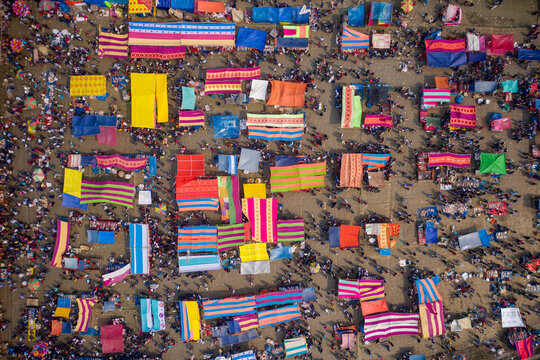 Aerial view of people in a local fish market with colourful bazaars in countryside near Gabtali, Rajshahi, Bangladesh.