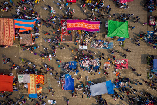 Aerial view of people in a local fish market with colourful bazaars in countryside near Gabtali, Rajshahi, Bangladesh.
