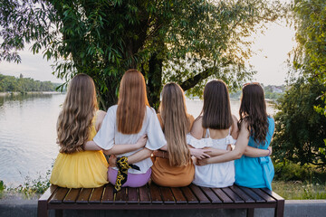 Group of happy young women, female friends having fun on summer nature background. Many young...