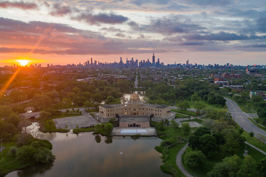 Aerial view of Garfield Park Gold Dome Field House in Garfield Park with city downtown in background at sunset, Chicago, Illinois, United States.
