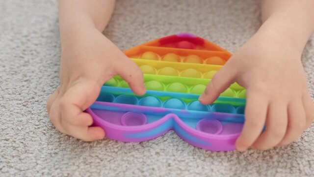 Close-up rainbow soothing pop it toy heart for development of fine motor skills. Trendy anti-stress toy pop it. toys for children and adults. Tap on the bubbles. Popular toy. Trend toy 2021 year.