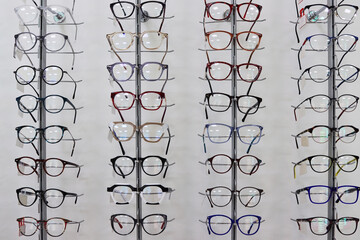 Glasses shop. Optical salon. Different multi-colored frames for eyeglasses in the shop window