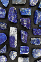 Lapis lazuli rare jewel stones texture on black stone background
