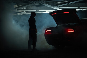 Drug Dealer Awaiting His Client Under Railroad Bridge at Night