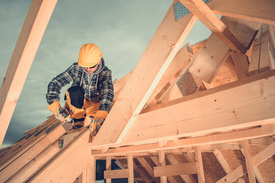 Wooden House Roof Beams Assembly By Construction Worker