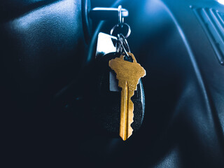 gold key hanging from the ignition 