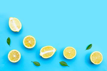 Fresh lemon with green leavs on blue background.