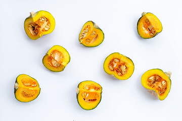 Fototapeta premium Green pumpkin pieces on white.