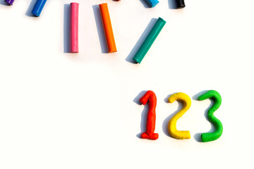 Number made of colorful plasticine clay on white.